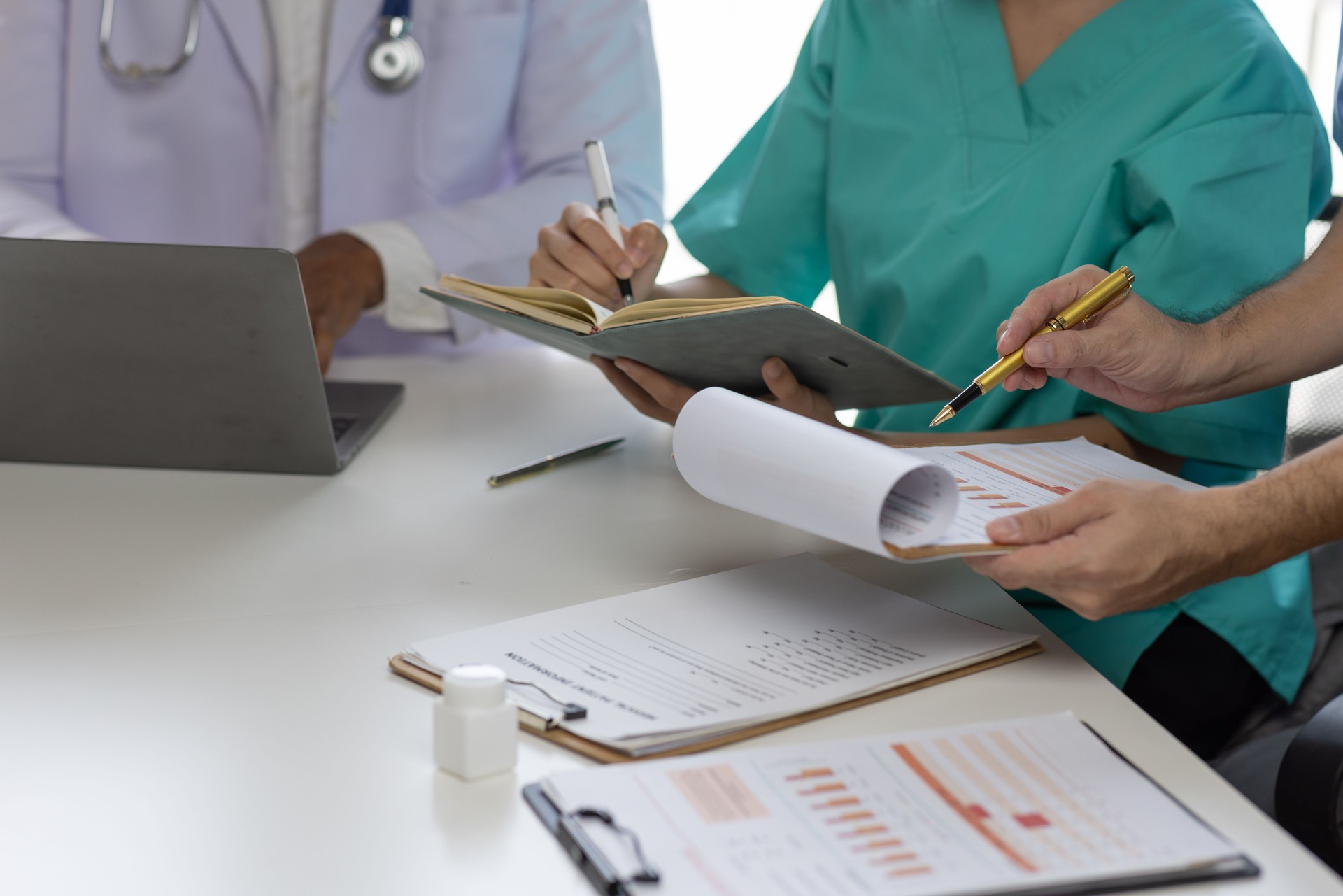 Medical, meeting and healthcare workers for team in office, discussion, brainstorming and planning. Doctor, nurse and computer on desk show diversity in collaboration or workshop for data analytics